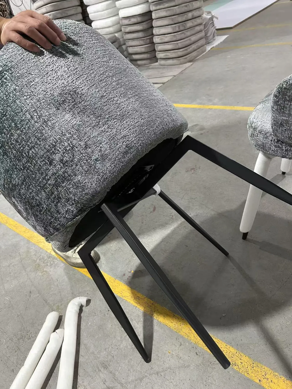 Underside and black leg structure of the upholstered swivel dining chair sample
