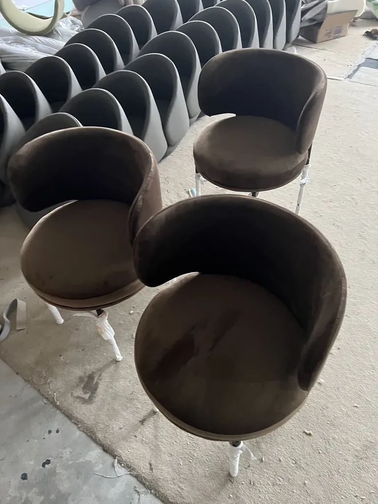 22205 chairs in brown velvet, with more chair shells in production behind