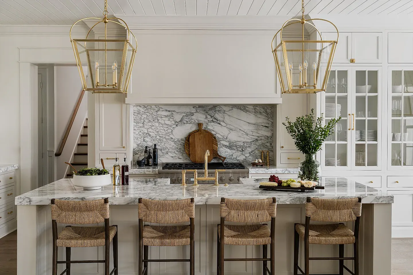 Woven stools at a marble kitchen counter — illustrative lifestyle scene