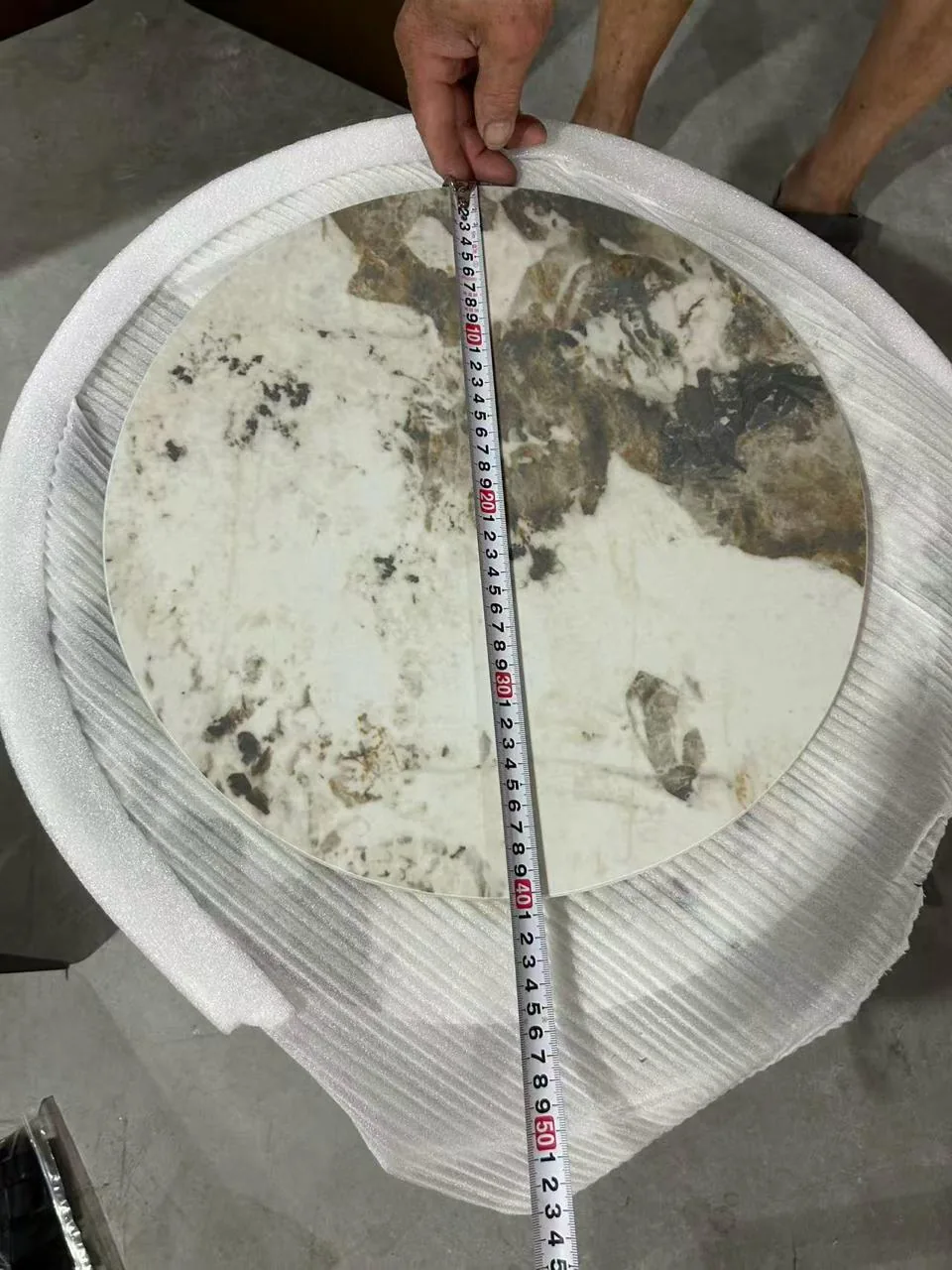 Tape measure across a small Pandora-pattern tabletop
